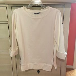 Peach lightweight sweat shirt with zipper detail on both sides.